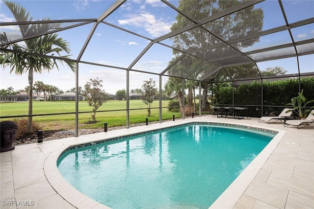 view of swimming pool featuring a patio and a lanai