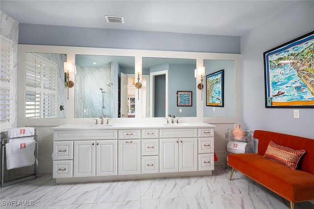 bathroom with vanity and a shower with door