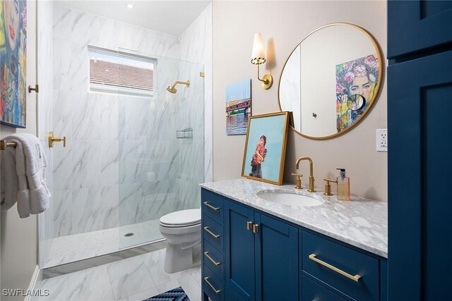 bathroom featuring vanity, toilet, and a tile shower