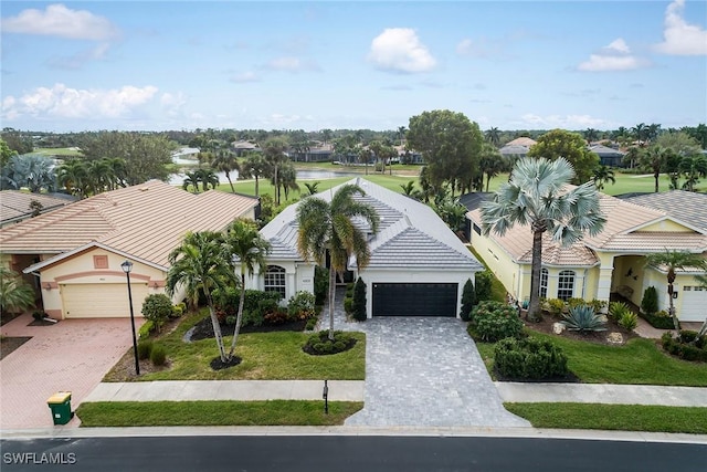 ranch-style home with a garage and a front lawn