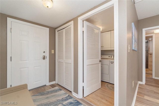 entryway featuring washer / clothes dryer and light hardwood / wood-style floors