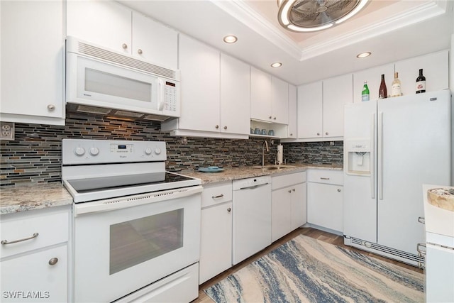 kitchen featuring white cabinetry, sink, and white appliances