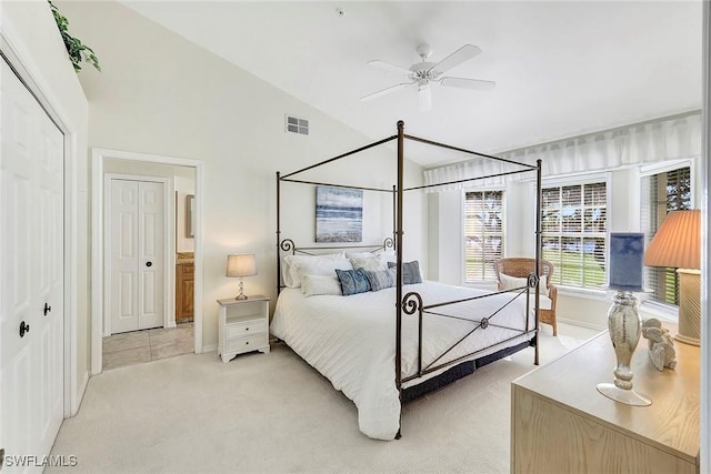 carpeted bedroom featuring a closet, vaulted ceiling, and ceiling fan