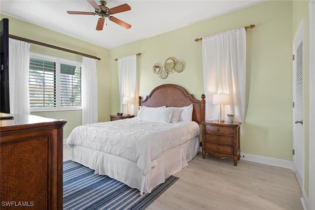 bedroom featuring a closet, light hardwood / wood-style flooring, and ceiling fan