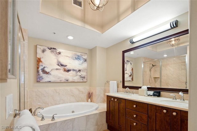 bathroom featuring vanity and independent shower and bath