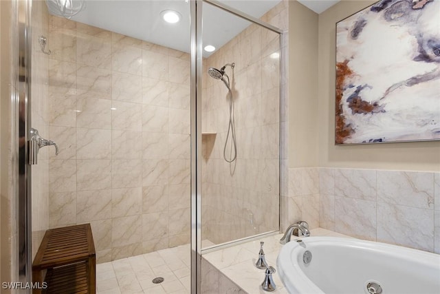 bathroom featuring separate shower and tub and tile walls