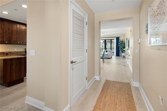 hall featuring french doors and light wood-type flooring