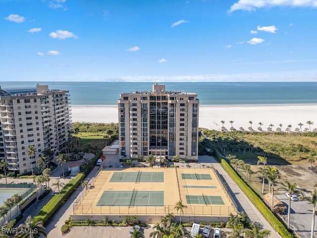 birds eye view of property with a water view and a beach view