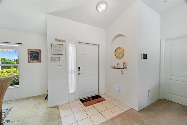 view of carpeted foyer entrance