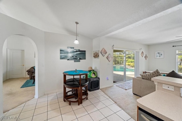 carpeted living room with ceiling fan and a textured ceiling