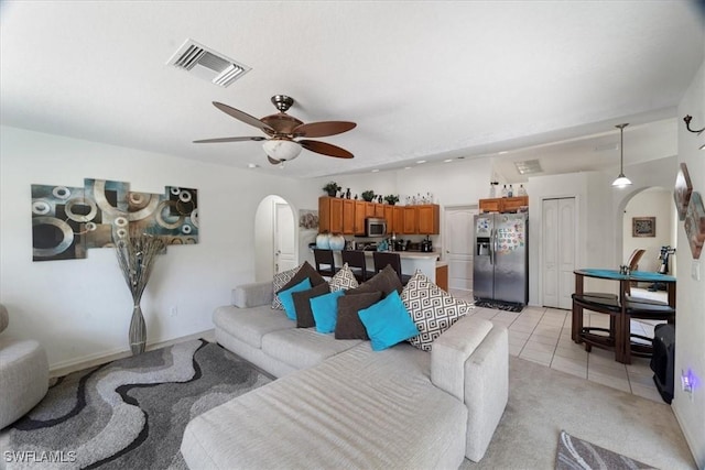 living room with light tile patterned floors and ceiling fan