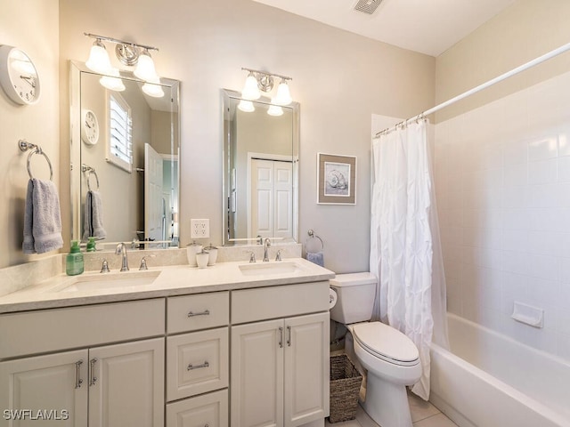 full bathroom featuring tile patterned floors, vanity, toilet, and shower / bath combo with shower curtain