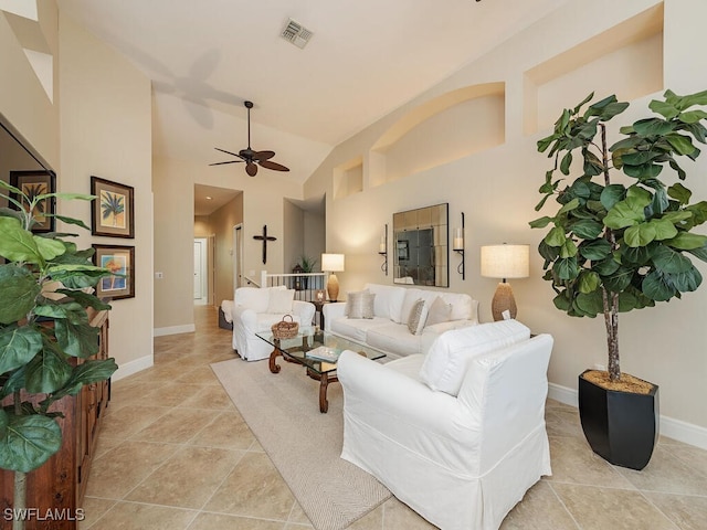 tiled living room with ceiling fan and high vaulted ceiling