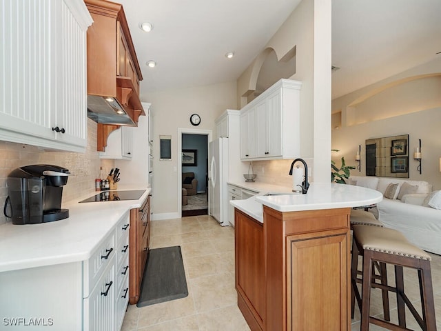 kitchen featuring sink, white cabinets, white fridge, and vaulted ceiling