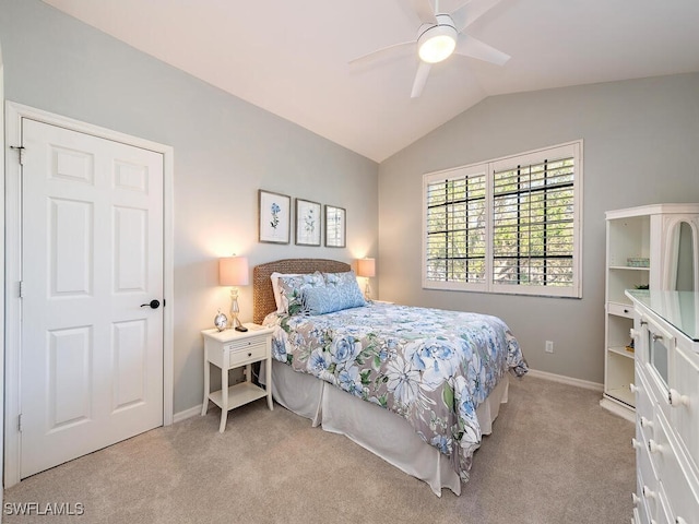 bedroom with ceiling fan, light colored carpet, and vaulted ceiling