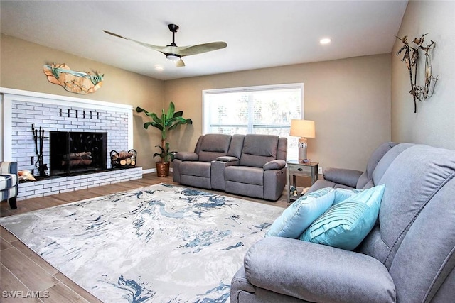 living room with a fireplace, hardwood / wood-style flooring, and ceiling fan