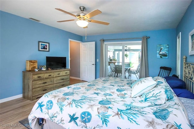 bedroom featuring access to exterior, light hardwood / wood-style floors, and ceiling fan