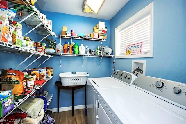 clothes washing area with washer and dryer and hardwood / wood-style flooring