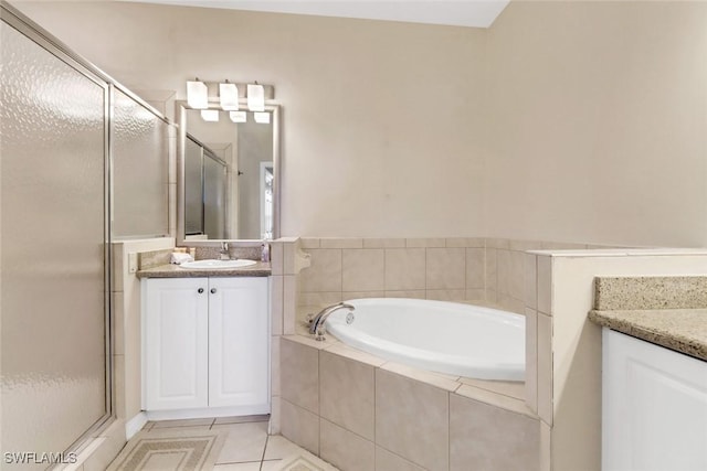 bathroom featuring tile patterned flooring, vanity, and independent shower and bath