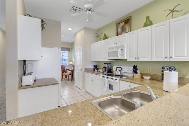 kitchen with white appliances, sink, ceiling fan, light tile patterned floors, and white cabinetry