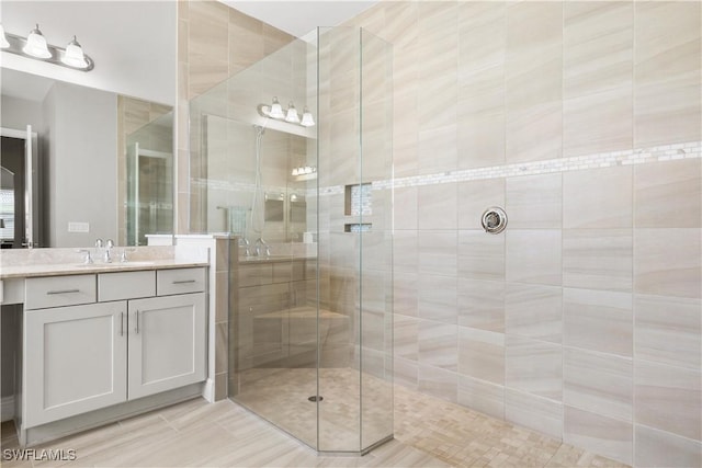 bathroom featuring vanity and tiled shower