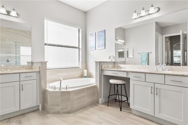 bathroom featuring hardwood / wood-style floors, vanity, and plus walk in shower