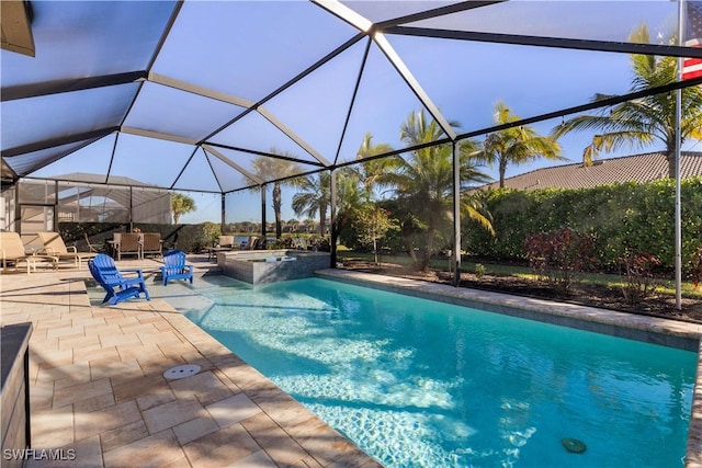 view of swimming pool with a lanai, a patio area, and an in ground hot tub