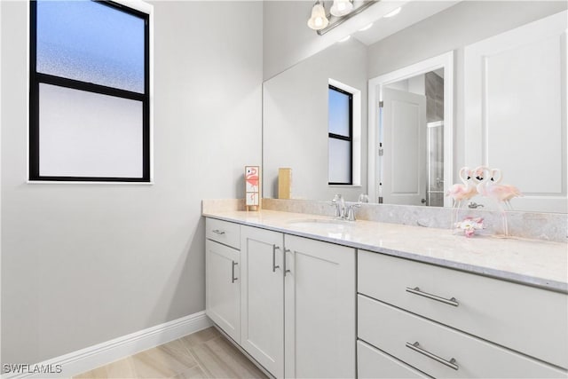 bathroom featuring hardwood / wood-style floors, vanity, and a wealth of natural light