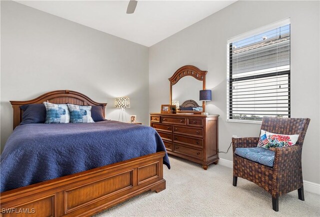 bedroom with ceiling fan and light colored carpet