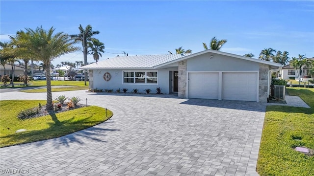 single story home with a front yard and a garage