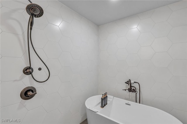 bathroom with a tub to relax in and tile walls