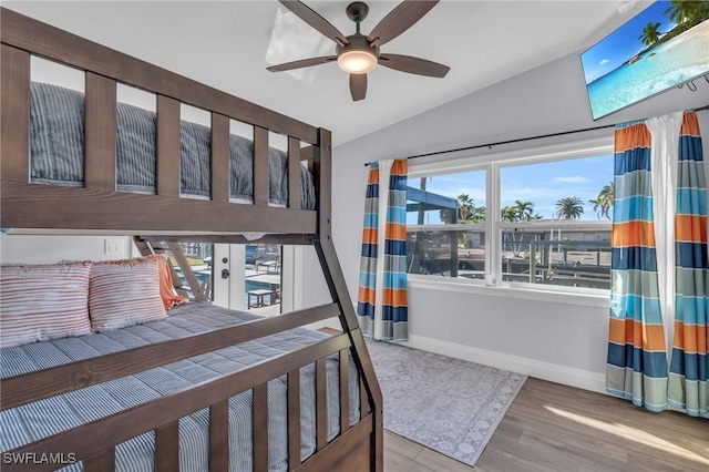 bedroom with light wood-type flooring, ceiling fan, and lofted ceiling