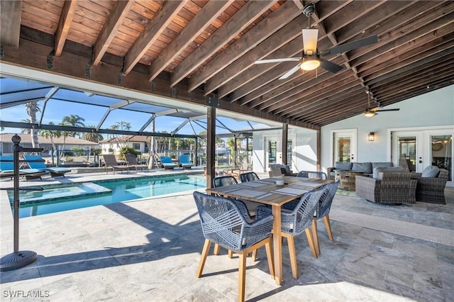 view of patio featuring glass enclosure, an outdoor living space, and ceiling fan