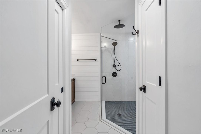 bathroom with tile patterned floors, vanity, and walk in shower