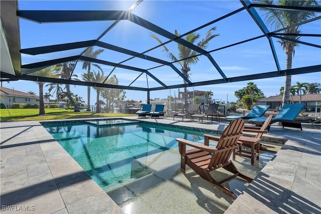 view of swimming pool with glass enclosure and a patio