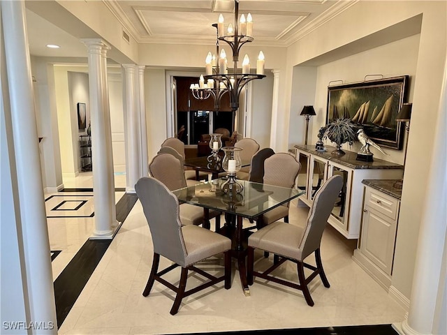 dining area with decorative columns, an inviting chandelier, and crown molding