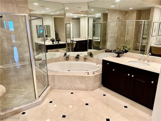 bathroom featuring tile patterned floors, vanity, and shower with separate bathtub