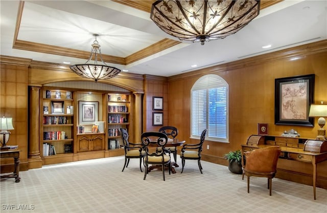 living area featuring light colored carpet, ornamental molding, and a notable chandelier