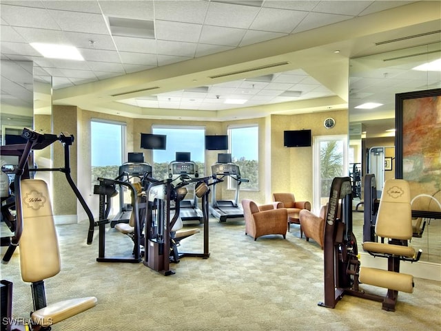 workout area with a drop ceiling and carpet floors