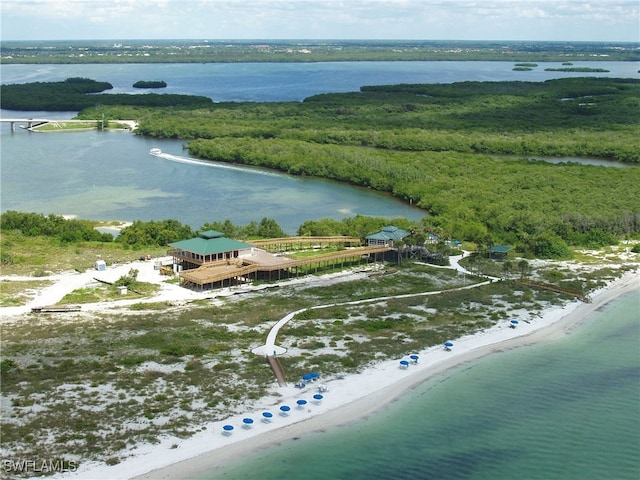 drone / aerial view featuring a water view and a view of the beach