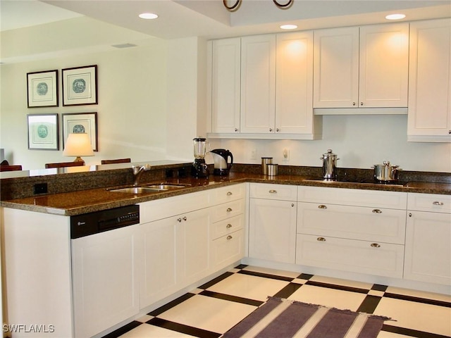 kitchen with white cabinetry, dishwasher, dark stone counters, and sink