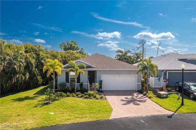 ranch-style home featuring a garage and a front lawn