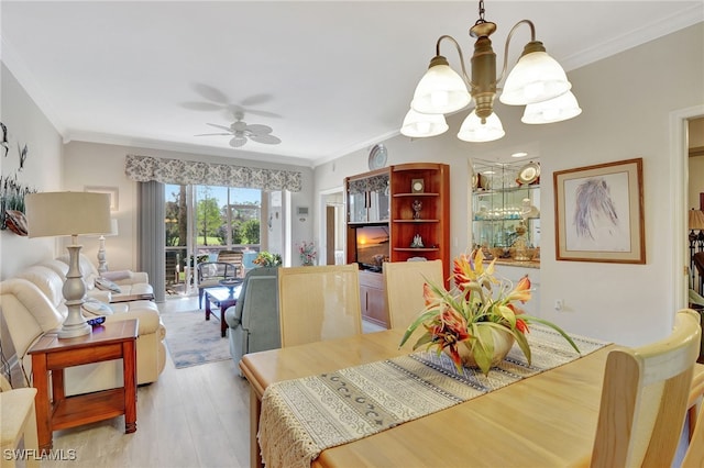 dining room with ceiling fan with notable chandelier, light hardwood / wood-style floors, and ornamental molding