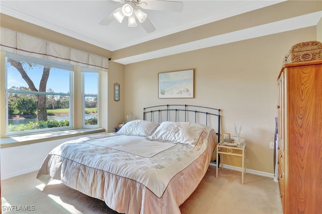 carpeted bedroom with ceiling fan and ornamental molding