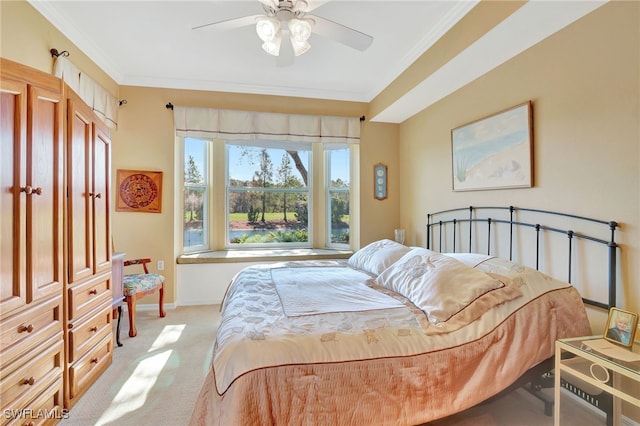 carpeted bedroom featuring ceiling fan and ornamental molding