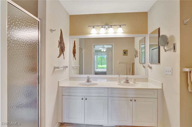 bathroom featuring vanity and a shower with door