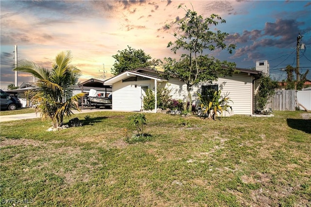 view of front of property with a yard and a carport