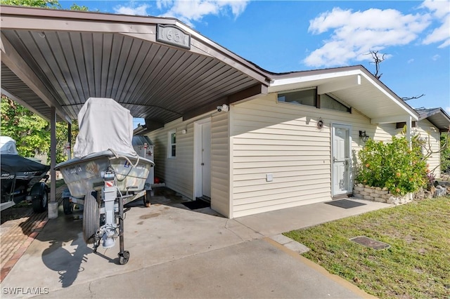 view of side of property with a yard and a carport