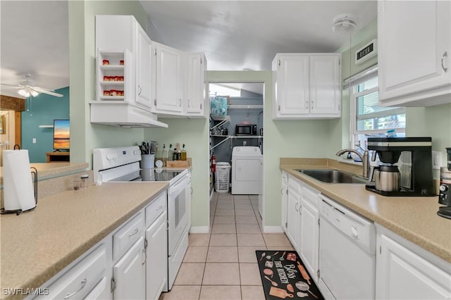 kitchen with washer / clothes dryer, sink, white cabinets, and white appliances