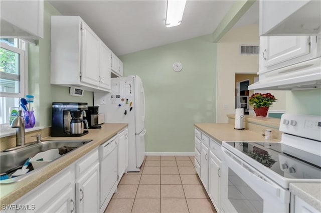 kitchen featuring white cabinetry, sink, lofted ceiling, white appliances, and light tile patterned floors